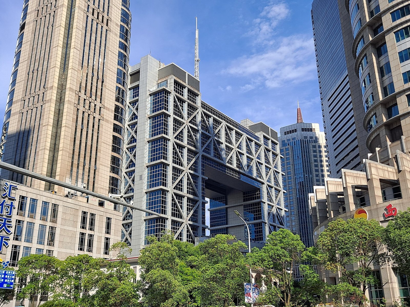 <em>The Shanghai Stock Exchange. The STAR50 index of AI and semiconductor names “/><figcaption><em>The Shanghai Stock Exchange. The STAR50 index of AI and semiconductor names is down about 40% from its summer high. Photo: 钉钉, CC BY-SA 4.0, via Wikimedia Commons</em></figcaption></figure>
<h3>The multiple has not reset</h3>
<p>Here the arithmetic gets uncomfortable for anyone calling the bottom. After a 40% decline, the STAR50 still trades at roughly 100 times trailing earnings; the Nasdaq 100 trades at about 30. That is a gap of 3.3 times, and it is the gap that has to close before “post-crash” means “cheap”.</p>
<p>Close it through earnings rather than price and profits across the index have to triple. At 25% annual growth that takes 5.4 years; at 40% — the rate Chinese AI champions are assumed to deliver — it takes 3.6 years. Neither is impossible. Both require four years without a price war, which is precisely what practitioners warn about. “Just like all other Chinese manufacturers, they will eventually end up in a price war,” said Shanghai fund manager Wang Zhuo. “All bubbles inevitably burst.”</p>
<h3>The debut premium is still there</h3>
<p>The damage has been unevenly distributed. MetaX jumped 700% on its debut last year and has halved since July; measured from the listing price, those two data points still leave it up roughly 300%. Moore Threads rose 400% and halved, still around 150% above debut. Unitree, 8,000 times oversubscribed by retail at its August listing, has halved from its first day. CXMT is down more than a quarter in a month. Optical suppliers Zhongji Innolight and Eoptolink sit about 60% below their summer highs, partly on US procurement risk.</p>
<p>The pattern is consistent: the more a stock ran on debut, the less the crash has returned it to anything resembling pre-hype levels. What has been destroyed is momentum, not valuation — and momentum is what a market dominated by small investors was actually trading.</p>
<figure class=