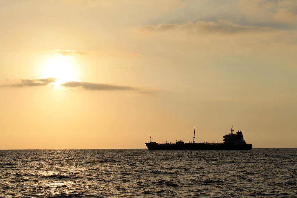 Silhouette of an oil tanker on the sea at sunset